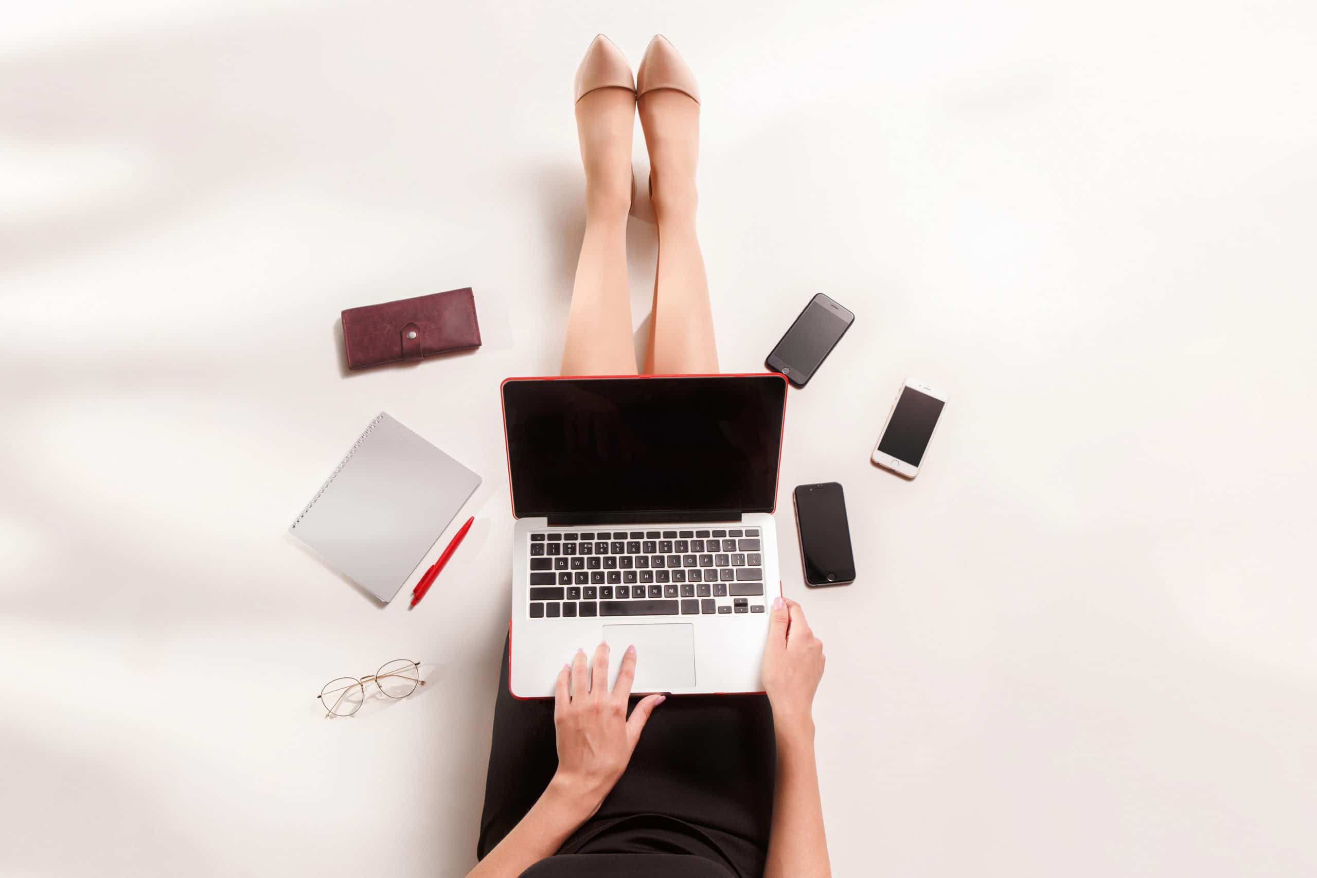 Fashion blogger writing on laptop computer.